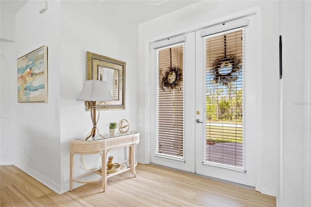 entryway with french doors, baseboards, and wood finished floors