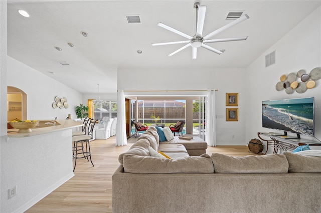 living area featuring visible vents, light wood-type flooring, and a ceiling fan