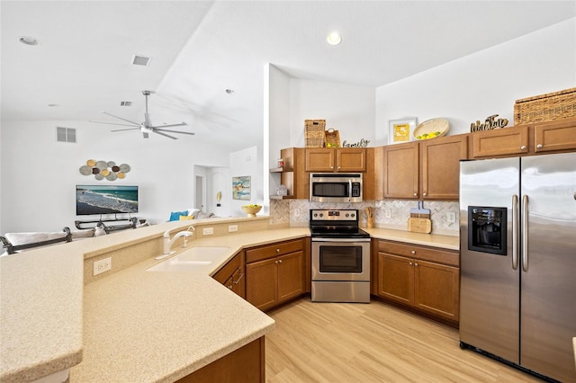 kitchen with light countertops, a ceiling fan, visible vents, stainless steel appliances, and a sink