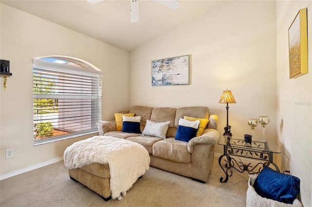 living area with baseboards, carpet floors, a ceiling fan, and lofted ceiling