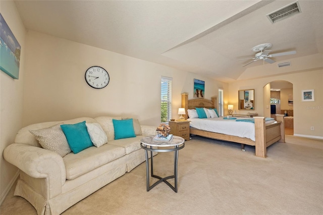 bedroom with arched walkways, visible vents, a ceiling fan, and carpet floors