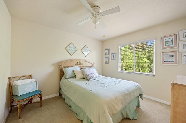 bedroom featuring light carpet, baseboards, and a ceiling fan