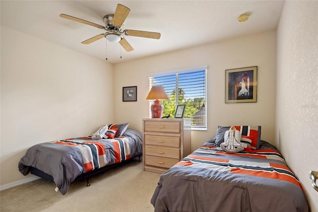 bedroom with ceiling fan and light colored carpet
