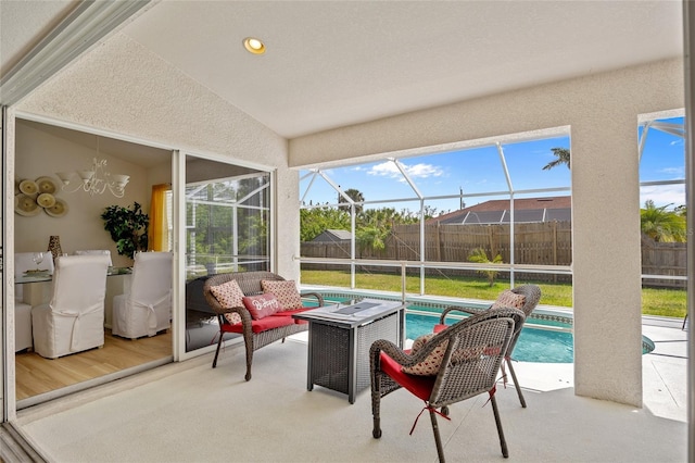 sunroom with an outdoor living space and a notable chandelier