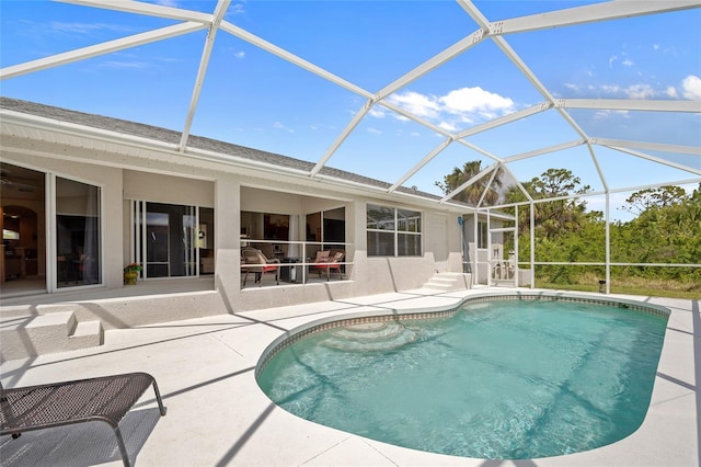 outdoor pool with a patio and glass enclosure