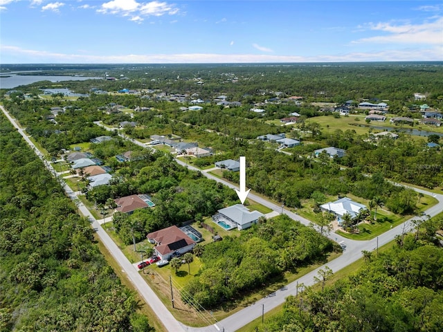 bird's eye view featuring a view of trees and a water view