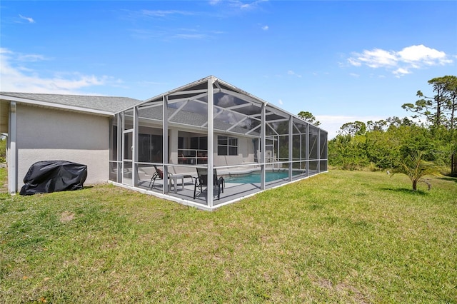 back of property featuring stucco siding, an outdoor pool, a patio area, a lanai, and a yard