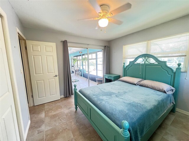 931 Juno Dr, Punta Gorda, FL 33950 - bedroom featuring access to outside, a ceiling fan, and light stone finish flooring