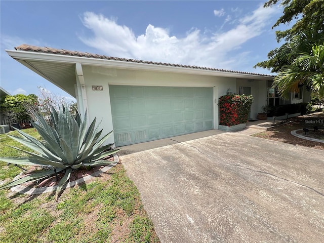 931 Juno Dr, Punta Gorda, FL 33950 - view of front of house featuring concrete driveway, stucco siding, an attached garage, and a tiled roof