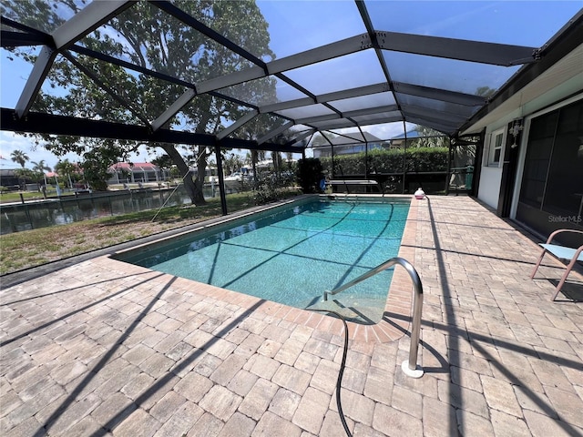 931 Juno Dr, Punta Gorda, FL 33950 - swimming pool with a patio, a water view, and glass enclosure