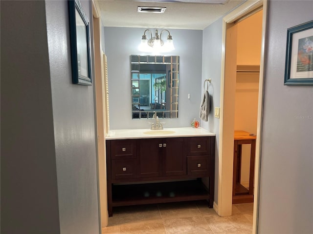 931 Juno Dr, Punta Gorda, FL 33950 - bathroom with vanity, a chandelier, and tile patterned flooring