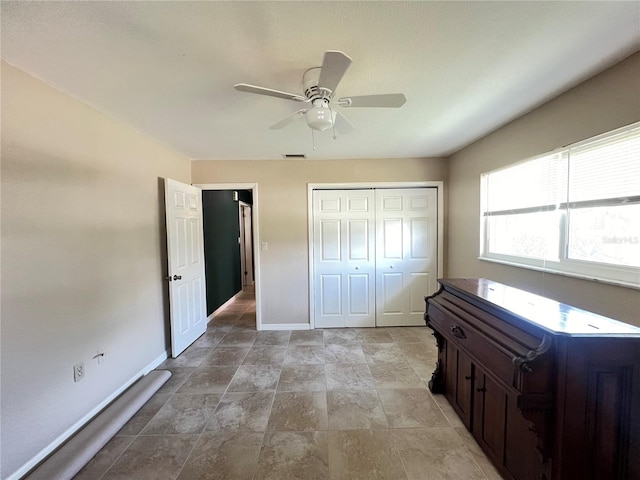 931 Juno Dr, Punta Gorda, FL 33950 - bedroom with a closet, ceiling fan, and light stone finish flooring