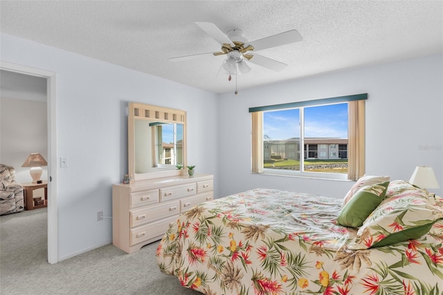 25100 Sandhill Blvd Unit R202, Punta Gorda, FL 33983 - bedroom with light colored carpet, a textured ceiling, and a ceiling fan