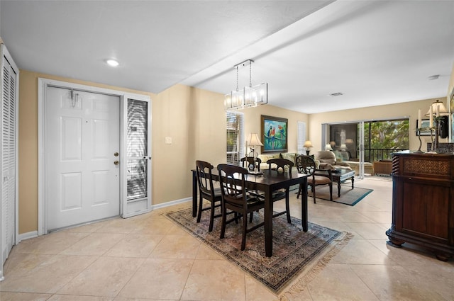 dining room with baseboards, visible vents, and light tile patterned floors
