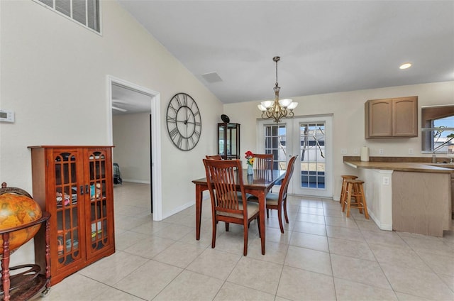 6344 Hera St, Englewood, FL 34224 - dining area featuring lofted ceiling, baseboards, visible vents, and a chandelier
