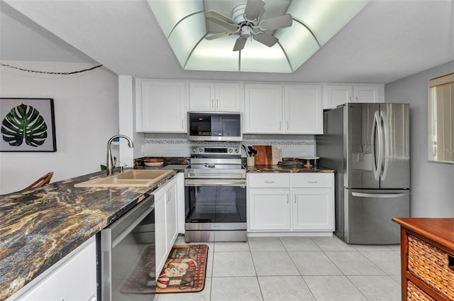 12274 SW Egret Cir Unit 2607, Lake Suzy, FL 34269 - kitchen with stainless steel appliances, a sink, white cabinets, light tile patterned floors, and dark stone countertops