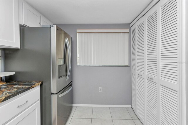 12274 SW Egret Cir Unit 2607, Lake Suzy, FL 34269 - kitchen featuring stainless steel fridge, white cabinetry, dark stone counters, baseboards, and light tile patterned floors