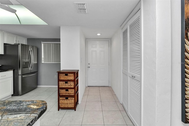 12274 SW Egret Cir Unit 2607, Lake Suzy, FL 34269 - kitchen with stainless steel fridge with ice dispenser, dark countertops, white cabinets, light tile patterned flooring, and recessed lighting