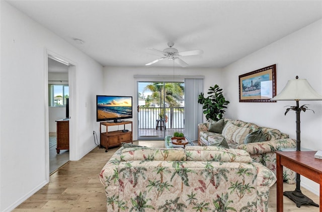 12274 SW Egret Cir Unit 2607, Lake Suzy, FL 34269 - living area featuring light wood-style flooring, a ceiling fan, and baseboards