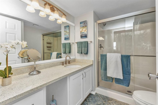 12274 SW Egret Cir Unit 2607, Lake Suzy, FL 34269 - bathroom featuring vanity, a shower stall, toilet, and tile patterned floors