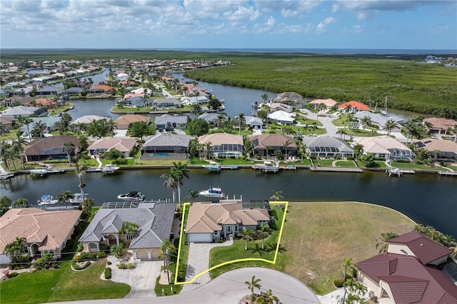 bird's eye view featuring a water view and a residential view