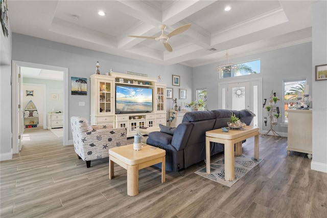 living room with a ceiling fan, beamed ceiling, light wood finished floors, and visible vents