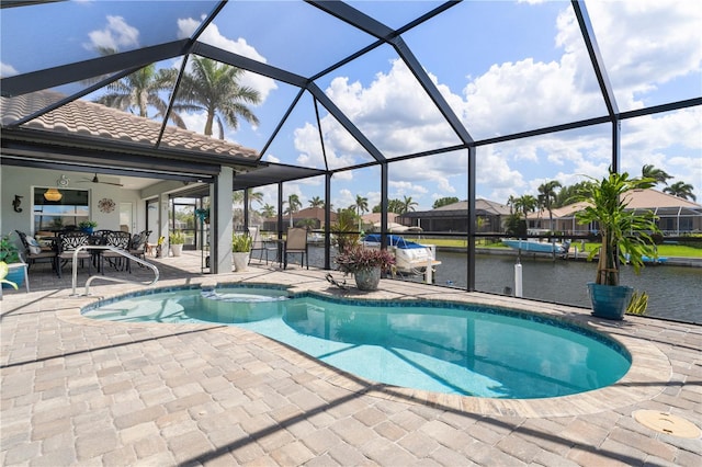 pool featuring a lanai, a water view, a ceiling fan, an in ground hot tub, and a patio area