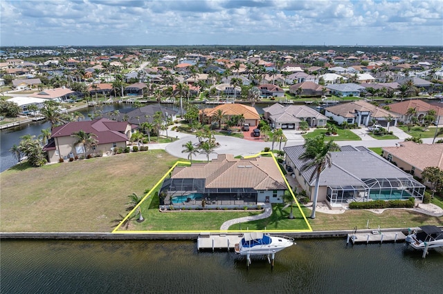 bird's eye view with a residential view and a water view