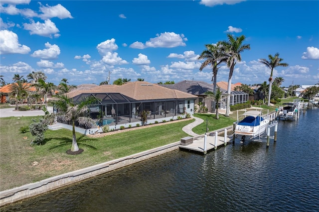 view of dock with glass enclosure, an outdoor pool, boat lift, a lawn, and a water view