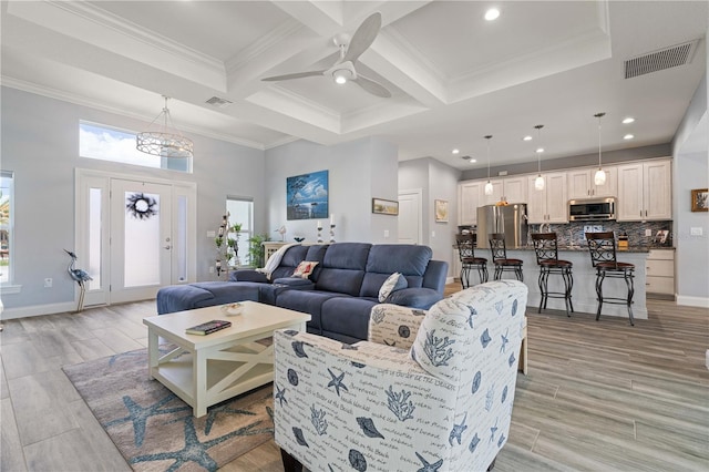 living area with beamed ceiling, visible vents, coffered ceiling, and crown molding