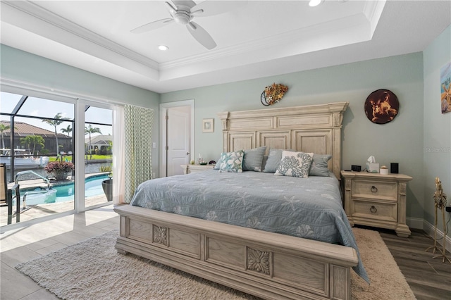 bedroom featuring a raised ceiling, baseboards, access to outside, and crown molding