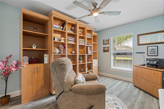 office area featuring baseboards, ceiling fan, and light wood-type flooring