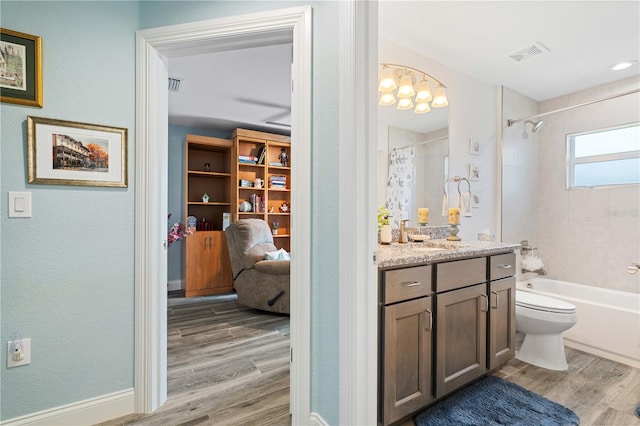 full bathroom with toilet, vanity, shower / bath combo, wood finished floors, and visible vents
