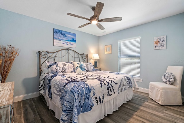 bedroom featuring baseboards, ceiling fan, and dark wood-style flooring