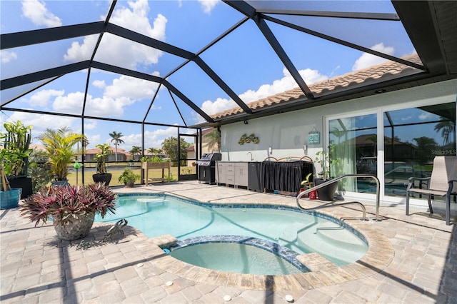view of swimming pool featuring a pool with connected hot tub, a lanai, a grill, and a patio