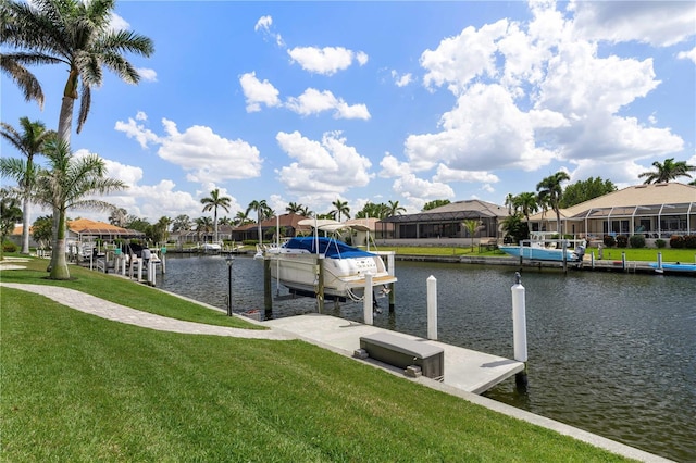 dock area with a water view, a lawn, boat lift, and a residential view