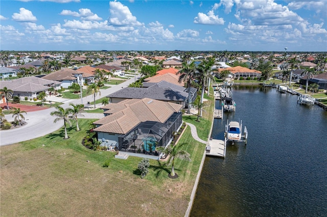 drone / aerial view with a residential view and a water view
