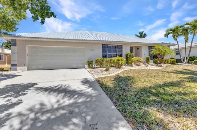 2718 Saint Thomas Dr, Punta Gorda, FL 33950 - single story home with a front lawn, metal roof, concrete driveway, a garage, and stucco siding