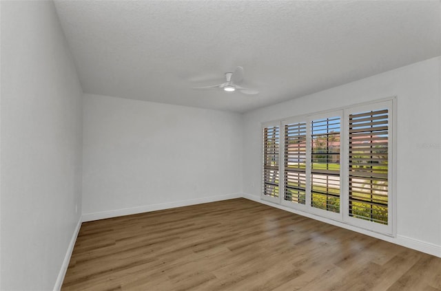 2718 Saint Thomas Dr, Punta Gorda, FL 33950 - unfurnished room with ceiling fan, baseboards, wood finished floors, and a textured ceiling