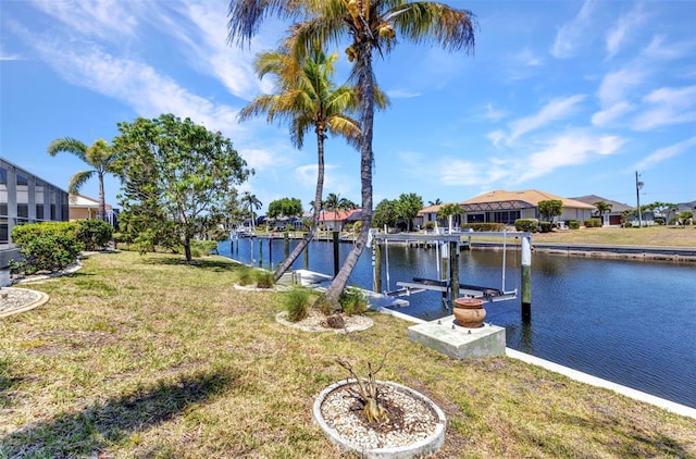 2718 Saint Thomas Dr, Punta Gorda, FL 33950 - view of dock with a residential view, boat lift, a yard, and a water view