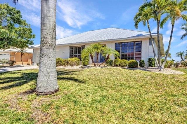 2718 Saint Thomas Dr, Punta Gorda, FL 33950 - single story home featuring metal roof, a front lawn, and stucco siding