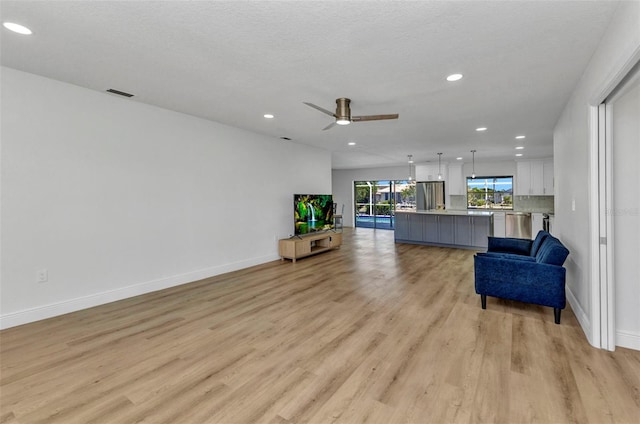2718 Saint Thomas Dr, Punta Gorda, FL 33950 - living area featuring a ceiling fan, light wood-type flooring, baseboards, visible vents, and recessed lighting