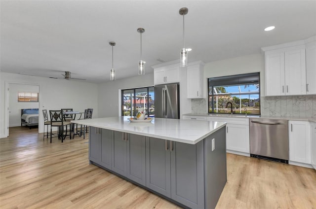 2718 Saint Thomas Dr, Punta Gorda, FL 33950 - kitchen with white cabinets, a ceiling fan, and stainless steel appliances