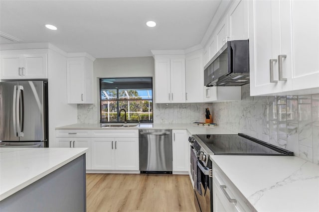 2718 Saint Thomas Dr, Punta Gorda, FL 33950 - kitchen featuring white cabinets, stainless steel appliances, and a sink