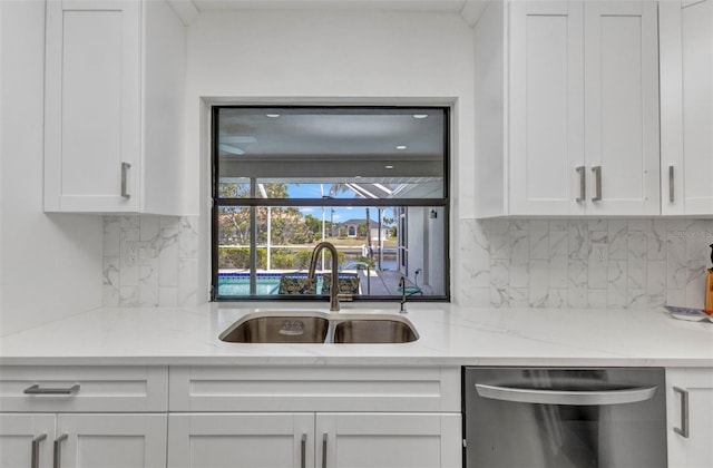 2718 Saint Thomas Dr, Punta Gorda, FL 33950 - kitchen featuring dishwasher, a sink, light stone countertops, tasteful backsplash, and white cabinetry