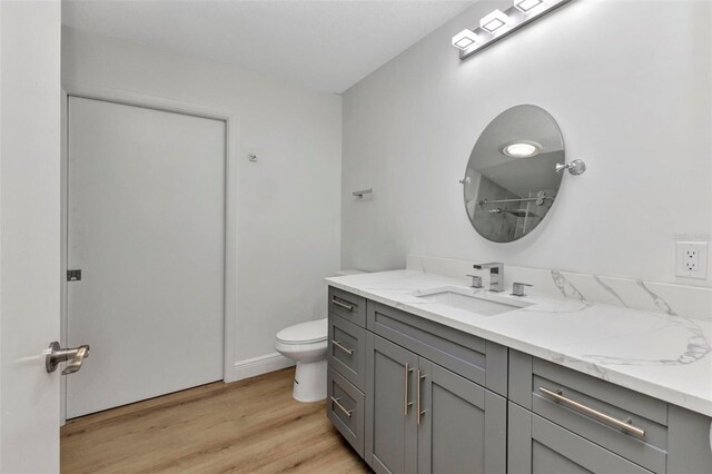 2718 Saint Thomas Dr, Punta Gorda, FL 33950 - full bathroom featuring wood finished floors, toilet, and vanity