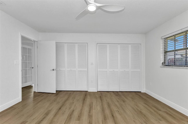 2718 Saint Thomas Dr, Punta Gorda, FL 33950 - unfurnished bedroom featuring light wood-style flooring, baseboards, and two closets