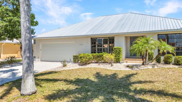 2718 Saint Thomas Dr, Punta Gorda, FL 33950 - ranch-style house with stucco siding, an attached garage, driveway, a front yard, and metal roof