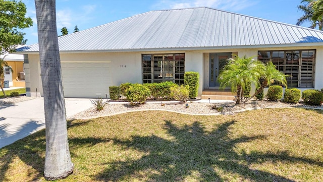 2718 Saint Thomas Dr, Punta Gorda, FL 33950 - single story home featuring driveway, metal roof, an attached garage, a front yard, and stucco siding