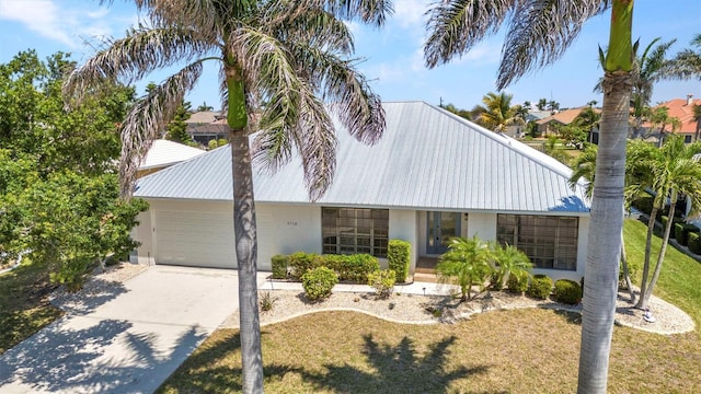 2718 Saint Thomas Dr, Punta Gorda, FL 33950 - mid-century modern home with a garage, concrete driveway, a front yard, and stucco siding